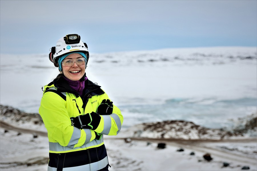 Woman wearing safety gear smiling to the camera